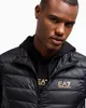 A man wearing a black puffer vest over a black hoodie. Produktbild-Vorschau