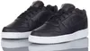 A pair of black Nike Ebernon Low sneakers with white soles, shown from a slightly angled front view on a reflective white surface. Produktbild-Vorschau