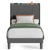 A bed with bedding and decorative items on the headboard. Produktbild-Vorschau