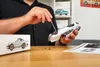 A person is assembling a model car with a screwdriver. Náhled obrázku produktu