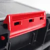 A close-up of a red latch on a black tool box. Náhled obrázku produktu