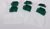A group of white vacuum cleaner bags with green and black plastic connectors are laid out on a white surface. Produktbild-Vorschau