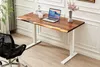 A modern home office setup featuring a live-edge wooden desk with white electric adjustable legs, a laptop, and a black office chair. Produktbild-Vorschau