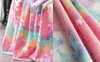 A close-up view of a soft, colorful blanket with a unicorn pattern. Náhľad obrázku produktu