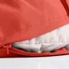 A close-up view of a red cushion with a zipper partially open, revealing a light gray inner lining. Produktbild-Vorschau
