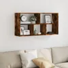 A wooden wall shelf mounted on a white wall above a sofa. Náhled obrázku produktu