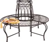 A round metal garden bench with a decorative lattice pattern, designed to surround a tree trunk. A straw hat and scarf are placed on the bench. Náhled obrázku produktu