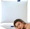 A white pillow is shown with a woman sleeping on another pillow in the foreground. Produktbild-Vorschau
