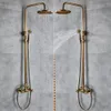 Two antique-style shower fixtures are shown side-by-side against a gray tiled wall, with water spraying from both. Náhled obrázku produktu