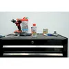 A collection of automotive maintenance products and tools are laid out on a black tool chest. Produktbild-Vorschau