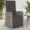 An outdoor patio scene with a rattan chair and a small table. Produktbild-Vorschau