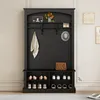 A black entryway hall tree with a bench and shoe storage, featuring a coat hook, hat, and decorative items. Anteprima dell’immagine prodotto