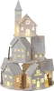 A multi-tiered illuminated Christmas village scene with houses and a church tower. Produktbild-Vorschau