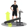 A man stands next to a black adjustable weight bench, with a yellow arrow indicating movement. Náhled obrázku produktu