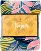 A folded blanket with a tropical leaf pattern is shown, with its packaging in the center. Podgląd zdjęcia produktu