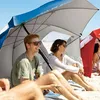 People relaxing on a beach under beach umbrellas. Voir les images du produit