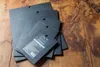 A stack of black cutting boards on a wooden surface. Produktbild-Vorschau