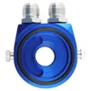 A blue and silver oil cooler adapter with two threaded fittings on top and two bolts on the sides. Voir les images du produit