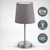 A close-up studio shot of a table lamp against a white and gray gradient background. Náhled obrázku produktu