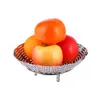 A metal steamer basket filled with fruits. Produktbild-Vorschau