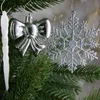 Close-up of Christmas tree ornaments hanging on a fir tree branch. Produktbild-Vorschau