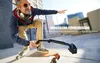 A man on a skateboard holding an action camera on a mount. Produktbild-Vorschau