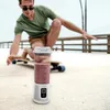 A man on a skateboard with a portable blender in the foreground. Podgląd zdjęcia produktu