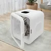 A cat is inside a white pet dryer with the door open, placed on a rug in a room. Náhled obrázku produktu