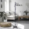 A modern living room with a couch, coffee table, and a coat rack. Voir les images du produit