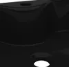 A close-up view of a black ceramic sink with a drain hole. Náhled obrázku produktu