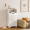 A white storage cabinet is shown in a room next to a sofa and a floor lamp. Náhled obrázku produktu