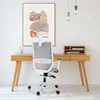 A modern office chair is placed in front of a wooden desk with a piece of abstract art on the wall. Náhľad obrázku produktu
