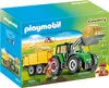 The image shows the packaging of a Playmobil Country tractor with trailer set, set in a rural farm scene. Voir les images du produit