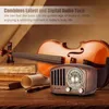 A vintage-style radio is placed on a wooden surface in front of a violin and books. Produktbild-Vorschau