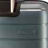 A close-up view of a blue suitcase with a textured surface and a small rectangular emblem. Produktbild-Vorschau
