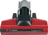 A close-up view of a red Bosch vacuum cleaner floor nozzle. Produktbild-Vorschau