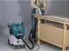 A person is using a circular saw on a workbench, with a vacuum cleaner attached to collect dust. Podgląd zdjęcia produktu