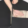 A hand is shown opening a black garment bag to reveal clothing inside. Anteprima dell’immagine prodotto