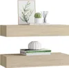 Two wooden shelves are displayed against a white background, each holding decorative items and books. Produktbild-Vorschau