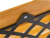 A close-up view of a wooden surface with a black lattice-like structure attached by a screw. Anteprima dell’immagine prodotto