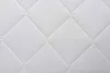 A close-up of a white quilted mattress surface. Náhľad obrázku produktu