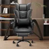 A black ergonomic office chair with a headrest and lumbar support is shown in a home office setting. Produktbild-Vorschau