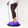 A person is using a purple balance trainer with resistance bands. Náhled obrázku produktu