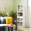 A living room scene with a blue sofa, a coffee table, a bookshelf, and wall art. Náhľad obrázku produktu