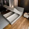 A bed with its storage compartments open, in a bedroom setting. Produktbild-Vorschau