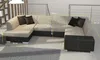 A sectional sofa with an ottoman in a modern living room setting. Náhled obrázku produktu