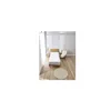 A bedroom scene with a bed, chair, and rug. Produktbild-Vorschau