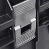 A close-up view of a black plastic latch mechanism on a modular storage system. Produktbild-Vorschau