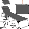 A gray foldable sun lounger with a headrest and a side pocket, shown in its unfolded state and also folded into a carrying case. Diagrams illustrating its adjustable features are also present. Náhled obrázku produktu