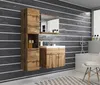 A modern bathroom vanity and storage unit with a wood grain finish against a dark, horizontally striped wall. Náhled obrázku produktu